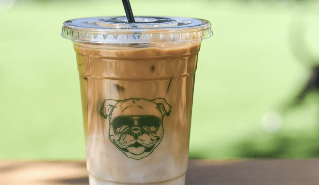 clear coffee cup with dog daze logo